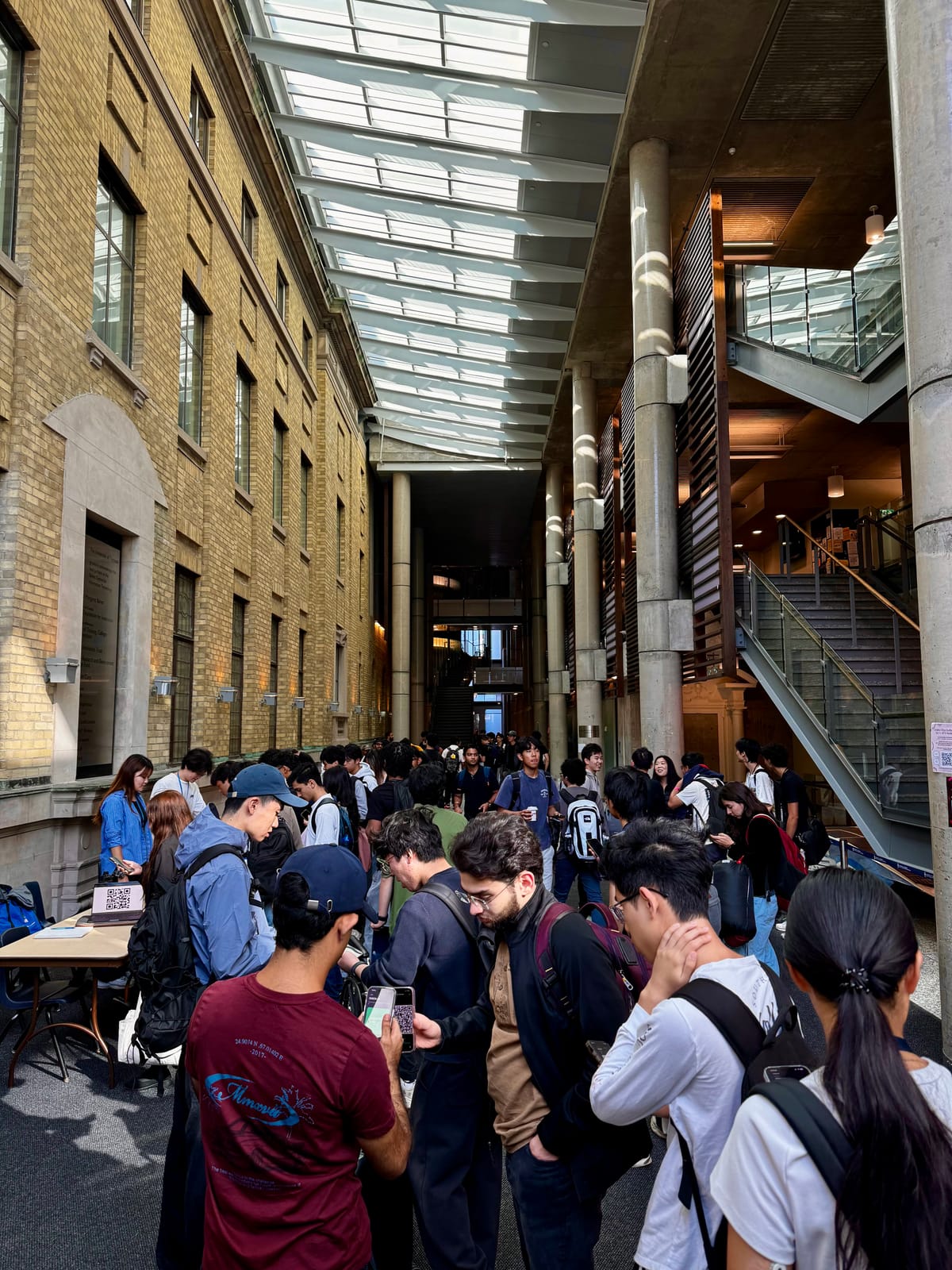 Crowd of students gathering in the Bahen Centre atrium at the University of Toronto for check-in.