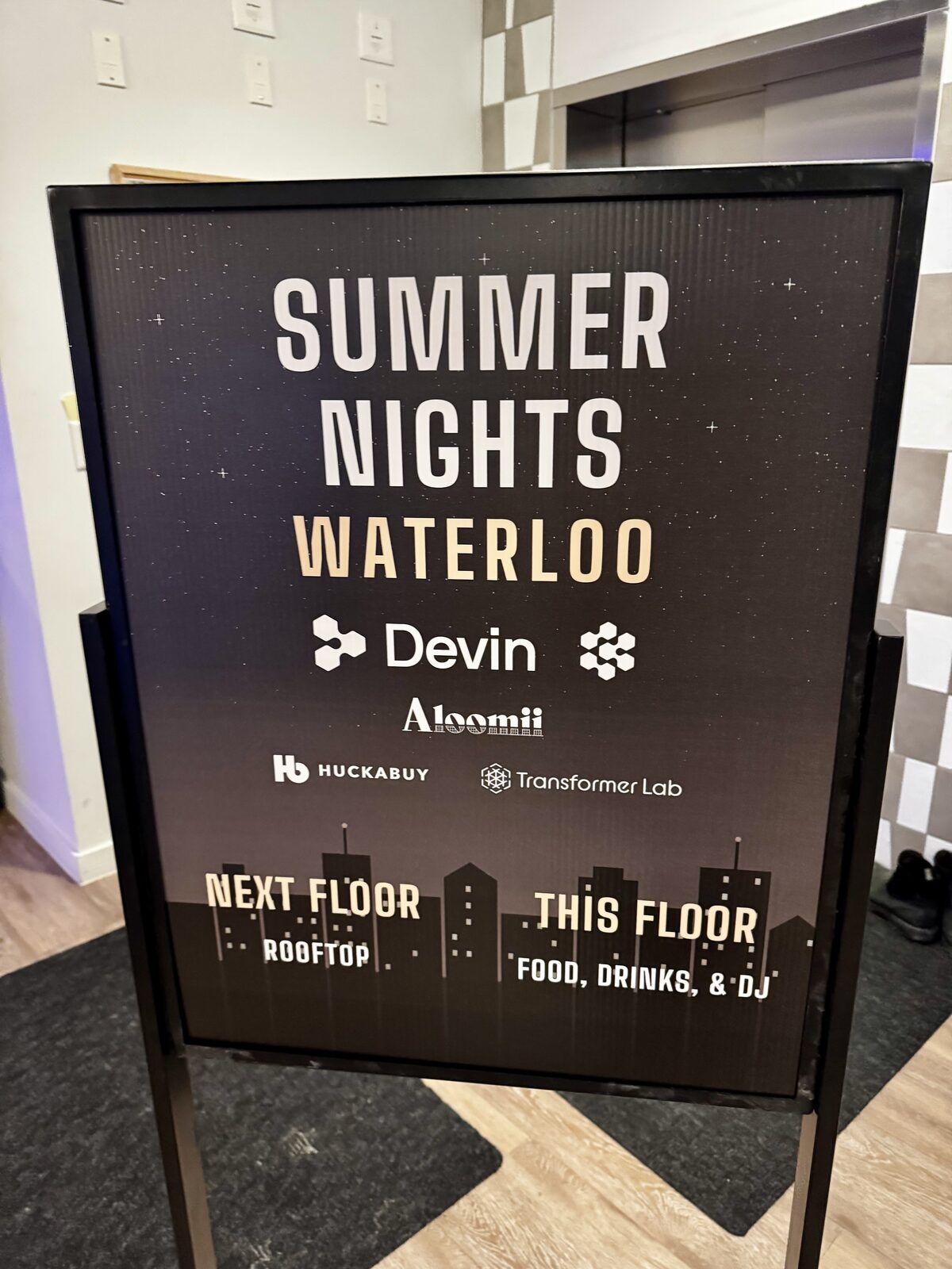 Summer Nights Waterloo event signage listing Devin, Cognition, Aloomii, Huckabuy, and Transformer Lab